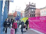 ??  ?? SAFETY Shoppers pass cordon in city centre