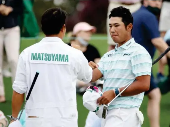  ??  ?? Hideki Matsuyama celebrates with his caddie Shota Hayafuji (Getty)