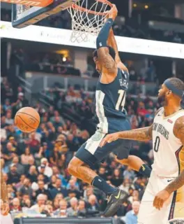  ?? John Leyba, The Post ?? Nuggets guard Gary Harris dunks after getting past New Orleans Pelicans center DeMarcus Cousins during the first quarter Friday.