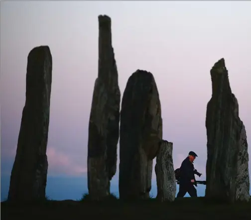  ?? PHOTOGRAPH BY JEFF J MITCHELL/GETTY IMAGES ?? Legend has it that the Callanish Stones on Lewis were once men, turned into boulders as a punishment