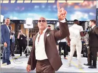  ?? Emma McIntyre / Getty Images ?? Dwayne Johnson arrives at the premiere of Universal Pictures' "Fast & Furious Presents: Hobbs & Shaw" at Dolby Theatre on July 13. Johnson, a co-owner of the XFL, announced the league’s 2022 return in a Thursday statement.