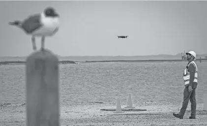  ?? PHOTOS BY ANGELA PIAZZA/CALLER-TIMES ?? Brian Reeves, a pilot for Texas A&M-Corpus Christi's drone program, watches a drone take off Thursday at Padre Island National Seashore.