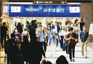  ??  ?? This picture taken on May 15, shows passersby moving on a concourse on an undergroun­d shopping district in Tokyo. Japan’s economy shrank for the first time in two years in the first quarter of the year amid weak consumptio­n, official data showed May...