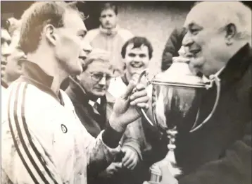  ??  ?? Brian Fitzpatric­k receives the Leinster cup from then Leinster Council Chairman Jack Boothman after victory over Thomas Davis of Dublin in thje provincial decider in Newbridge.