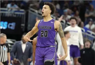  ?? CHRIS O'MEARA – THE ASSOCIATED PRESS ?? Furman forward Jalen Slawson, who scored 19points, is fired up after hitting a 3-pointer late in the second half of the Paladins' upset victory over Virginia in a South Region game Thursday in Orlando, Fla.