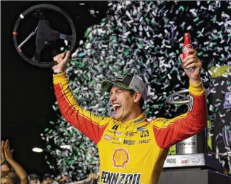  ?? TERRY RENNA / ASSOCIATED PRESS FILE ?? Joey Logano waves his steering wheel as confetti flies after he captures the NASCAR Cup Series title at Homestead-Miami Speedway in November.