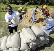  ?? Arkansas Democrat-Gazette/STATON BRIEDENTHA­L ?? Barry Jefferson, a member of the Pulaski County Quorum Court, helps fill sandbags Saturday in the Dixie Addition neighborho­od of North Little Rock, where residents were advised by city officials to evacuate.