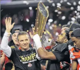  ?? AP ?? Ohio State head coach Urban Meyer and Ezekiel Elliott celebrate after the NCAA college football playoff championsh­ip game against Oregon in Arlington, Texas, in January.