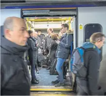  ?? Photograph: Robert Perry ?? Commuters on a train in central Glasgow