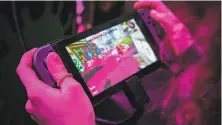  ?? Gabrielle Lurie / The Chronicle 2017 ?? Haylie Ferreira, 18, tests the Nintendo Switch, the hybrid video game console, during a preview last year in San Francisco.