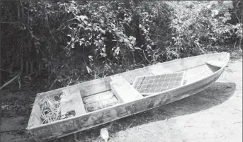  ??  ?? The bandits’ camouflage boat loaded with a solar panel that was stolen from the ranch.