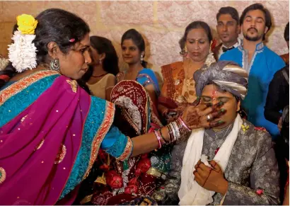  ?? Reuters file ?? A groom receives a dot on his forehead with Sindoor (red pigment) during a mass marriage ceremony in Karachi. —
