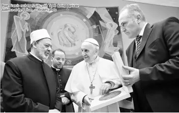  ??  ?? Pope Francis exchanges gifts with Tayeb during a private audience at the Vatican. — Reuters photo