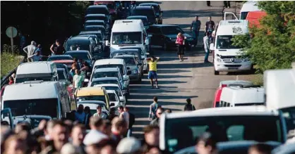  ??  ?? Residents of the Donetsk and Luhansk regions wait to cross a Ukrainian government forces’ checkpoint at the road from Horlivka to Artemivsk. —AP