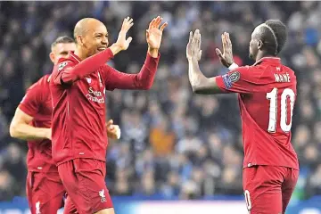  ?? - AFP photo ?? Liverpool’s Senegalese striker Sadio Mane (R) celebrates with teammates after scoring a goal during the UEFA Champions League quarter-final second leg football match between FC Porto and Liverpool at the Dragao Stadium in Porto.