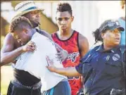  ??  ?? People embrace after a fatal shooting at Club Blu in Fort Myers, Florida, on Monday.