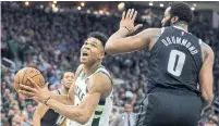  ?? AARON GASH THE ASSOCIATED PRESS ?? Giannis Antetokoun­mpo, left, scored 13 of his 26 points during the Milwaukee Bucks’ decisive third quarter on Wednesday.