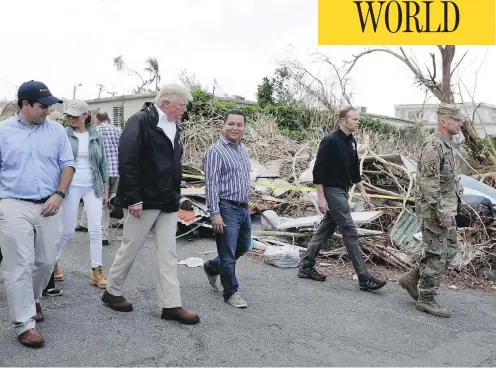  ?? EVAN VUCCI / THE ASSOCIATED PRESS ?? U.S. President Donald Trump, first lady Melania Trump and Puerto Rico Gov. Ricardo Rossell, left, take a walking tour on Tuesday to survey hurricane damage and recovery efforts in a neighbourh­ood in Guaynabo, Puerto Rico.