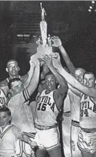  ?? AP PHOTO ?? Loyola team captain Jerry Harkness (15) raises the trophy high with his teammates after winning the NCAA regional title over Illinois in 1963.