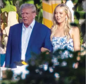  ?? ?? MR GRUMP: The tetchy ex-President escorts his daughter Tiffany on Friday. Left: But he smiled broadly later with his ex Marla Maples and wife Melania
