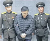  ?? CP PHOTO ?? Canadian pastor Hyeon Soo Lim, centre, is escorted to his sentencing in Pyongyang, North Korea.