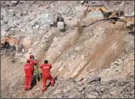  ?? (AP/Xinhua/Lian Zhen) ?? Rescuers work at the site of a collapsed open-pit coal mine Friday in Alxa Banner in northern China’s Inner Mongolia Autonomous Region.