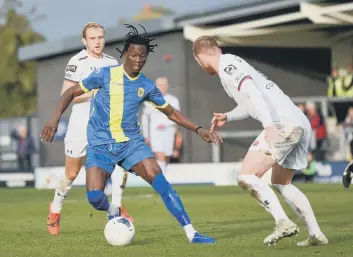  ??  ?? Maniche Sani (blue) on the ball for Peterborou­gh Sports at AFC Fylde last weekend