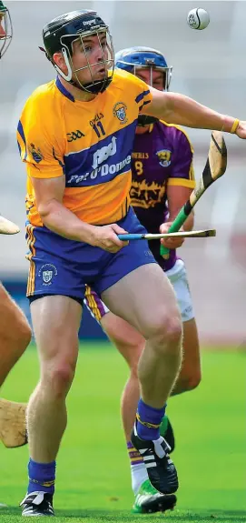  ??  ?? Tony Kelly attempts to get away from Wexford’s Kevin Foley during Clare’s victory over Wexford which set up a semi-final meeting with Galway