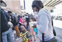  ?? Alejandro Tamayo San Diego Union-Tribune ?? of fencing, at top, separate Tijuana, left, and San Diego County. Asylum seekers in Tijuana, many of them children, plead at bottom left to enter the U.S. at the end of Trump’s “Remain in Mexico” policy, and join a line for food at bottom right.