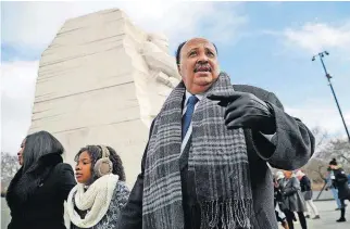  ?? [AP PHOTO] ?? Martin Luther King III, right, with his wife, Arndrea Waters, left, and their daughter, Yolanda, 9, center, are shown during their visit to the Martin Luther King Jr. Memorial on Monday on the National Mall in Washington.