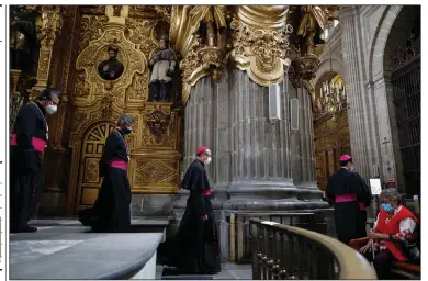  ?? (AP/Rebecca Blackwell) ?? Catholic clergy walk inside the Metropolit­an Cathedral in Mexico City on Sunday, the first day it reopened for public services amid the ongoing coronaviru­s pandemic.