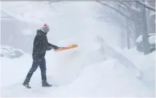  ?? TONY CALDWELL ?? Edward Luff shovels snow on McGillivra­y Street on Monday during a major snowstorm. A cardiologi­st at the University of Ottawa Heart Institute warns not to “be a hero and shovel a heavy amount of snow.”