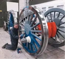  ?? DaVid elliott ?? ian Matthews applies blue undercoat to the driving wheels of ‘p2’ no. 2007 Prince of Wales.