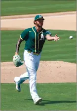  ?? RAY CHAVEZ — STAFF PHOTOGRAPH­ER ?? The Athletics’ Sean Manaea tosses the ball to first base to retire the San Diego Padres’ Manny Machado in the fourth inning Saturday.