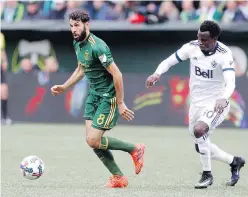  ??  ?? Diego Valeri, left, and the Timbers managed a 2-1 win over the Whitecaps in Portland on Sunday to win the Cascadia Cup.