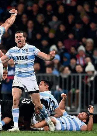  ?? GETTY IMAGES ?? The Pumas, above, celebrate their shock win last night in Christchur­ch. Left, All Blacks midfielder David Havili is tackled.