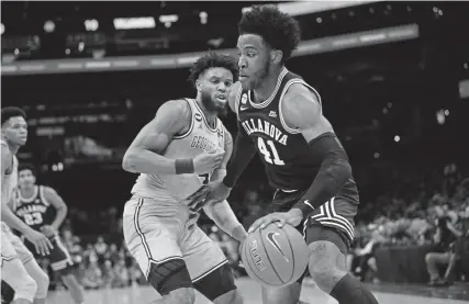  ?? Nick Wass, The Associated Press ?? Villanova forward Saddiq Bey, right, dribbles the ball against Georgetown guard Jagan Mosely. Bey or Florida State’s Devin Vassell are two possibilit­ies that Nuggets GM Tim Connelly might consider.