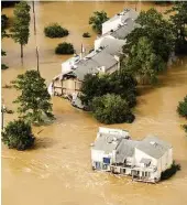  ?? Brett Coomer / Houston Chronicle ?? Floodwater­s from the San Jacinto River engulf condominiu­ms in Kingwood on Aug. 30 after the Lake Conroe dam releases began two days earlier.