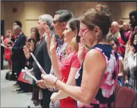  ?? Canadian Press photo ?? People take the citizenshi­p oath at Pier 21 immigratio­n centre in Halifax on July 1.