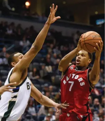  ?? BENNY SIEU/USA TODAY SPORTS ?? The Bucks’ Jabari Parker does his best to contain Raptors guard Kyle Lowry during second-quarter play Tuesday.