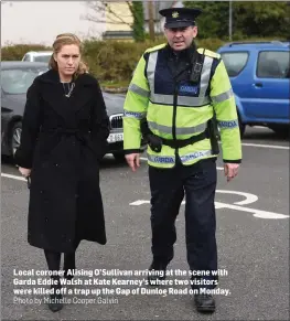  ?? Photo by Michelle Cooper Galvin ?? Local coroner Alising O’Sullivan arriving at the scene with Garda Eddie Walsh at Kate Kearney’s where two visitors were killed off a trap up the Gap of Dunloe Road on Monday.