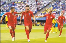  ?? Francisco Seco / Associated Press ?? England’s Harry Maguire, center, celebrates with his teammates after scoring his side’s opening goal on Saturday.