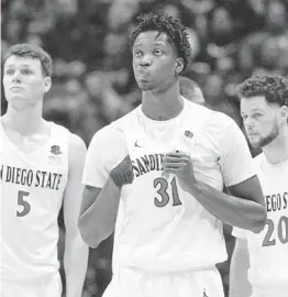  ?? HAYNE PALMOUR IV U-T ?? SDSU coach Brian Dutcher said that if Nathan Mensah (above) makes it back in time to play in the NCAA tourney, the 6-foot-10 forward would come off the bench.