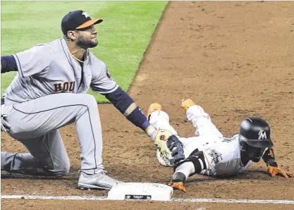  ?? ERIC ESPADA / GETTY IMAGES ?? Astros fifirst baseman Yuli Gurriel applies the tag to pick offff the Marlins’ Dee Gordon, ending the third inning. Gurriel later added a grand slam that gave Houston a 4-1 lead in the sixth inning. The Marlins have lost 15 of their last 19 games.