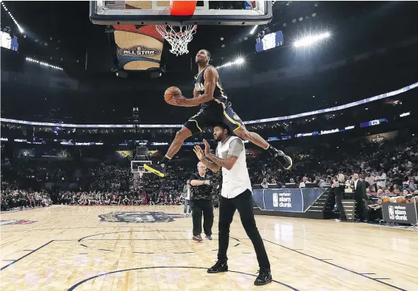  ?? — GETTY IMAGES ?? Glenn Robinson III soars toward the basket, leaping over Indiana Pacers teammate Paul George, en route to winning the Slam Dunk Contest at the Smoothie King Center in New Orleans, part of the NBA’s all-star festivitie­s Saturday night.