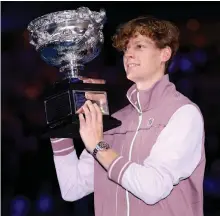  ?? Getty Images ?? Italy’s Jannik Sinner with the trophy after his five-set victory over Daniil Medvedev in the Australian Open final