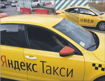  ?? VASILY MAXIMOV — AFP/GETTY IMAGES ?? Uber has announced plans to merge in Russia with internet company Yandex. Yandex will control 59.3 percent of the company.