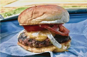  ?? Alison Cook / Staff ?? Burger with cheddar, smoked mayonnaise, grilled onion and tomato from Gatlin’s BBQ