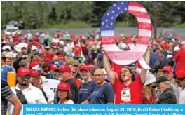  ??  ?? WILKES BARRES: In this file photo taken on August 01, 2018, David Reinert holds up a large “Q” sign while awaiting the arrival of US President Donald Trump at a “Make America Great Again” rally at the Mohegan Sun Arena, Casey Plaza. — AFP