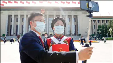  ?? Photo: cnsphoto ?? Deputies to the 13th National People’s Congress (NPC) take photo at the Great Hall of the People after the closing meeting of the third session of the 13th NPC in Beijing, Capital of China, on Thursday.